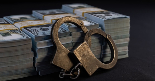 embezzled money with handcuffs