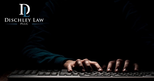 shadowy hands on keyboard in dark room