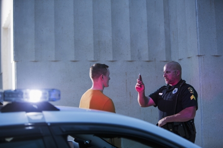 Policeman performing sobriety test on driver